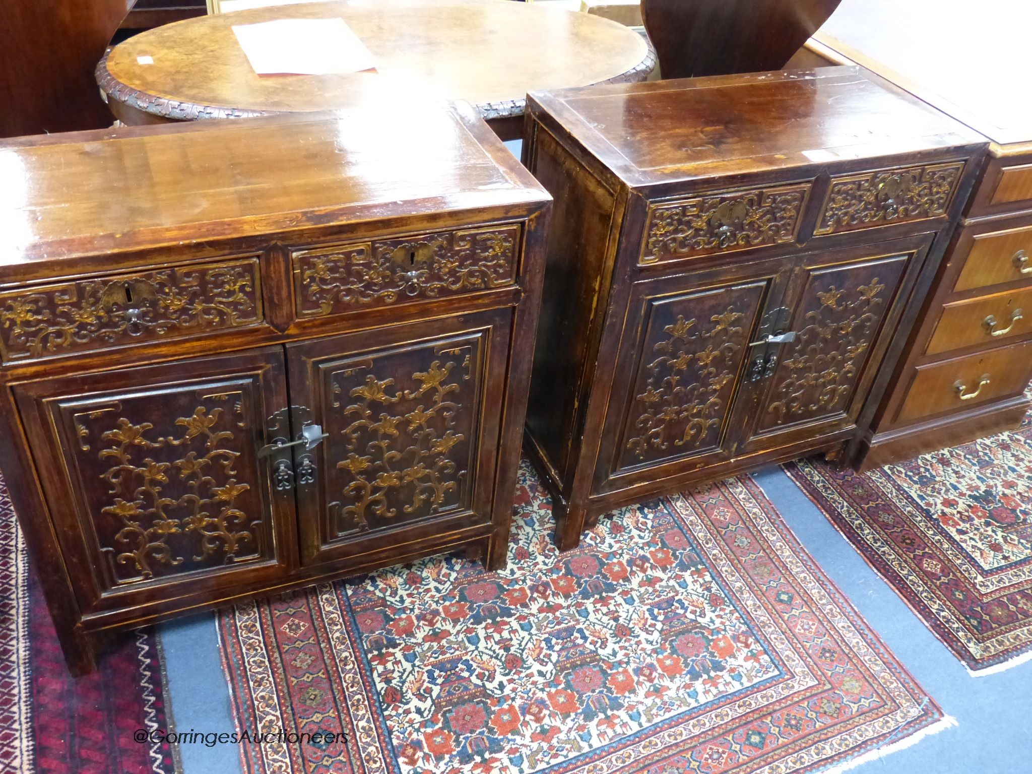 A pair of Chinese carved cabinets, the fronts carved with foliage in low relief, width 69cm, depth 33cm, height 76cm